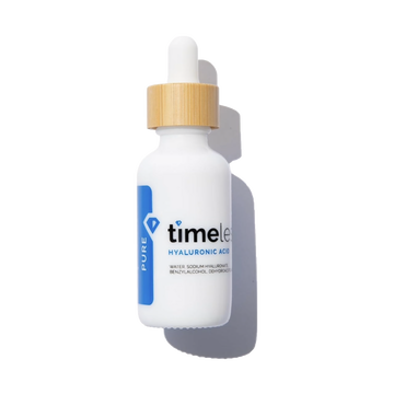 White dropper bottle with gold cap labeled 'timeless' on a white background