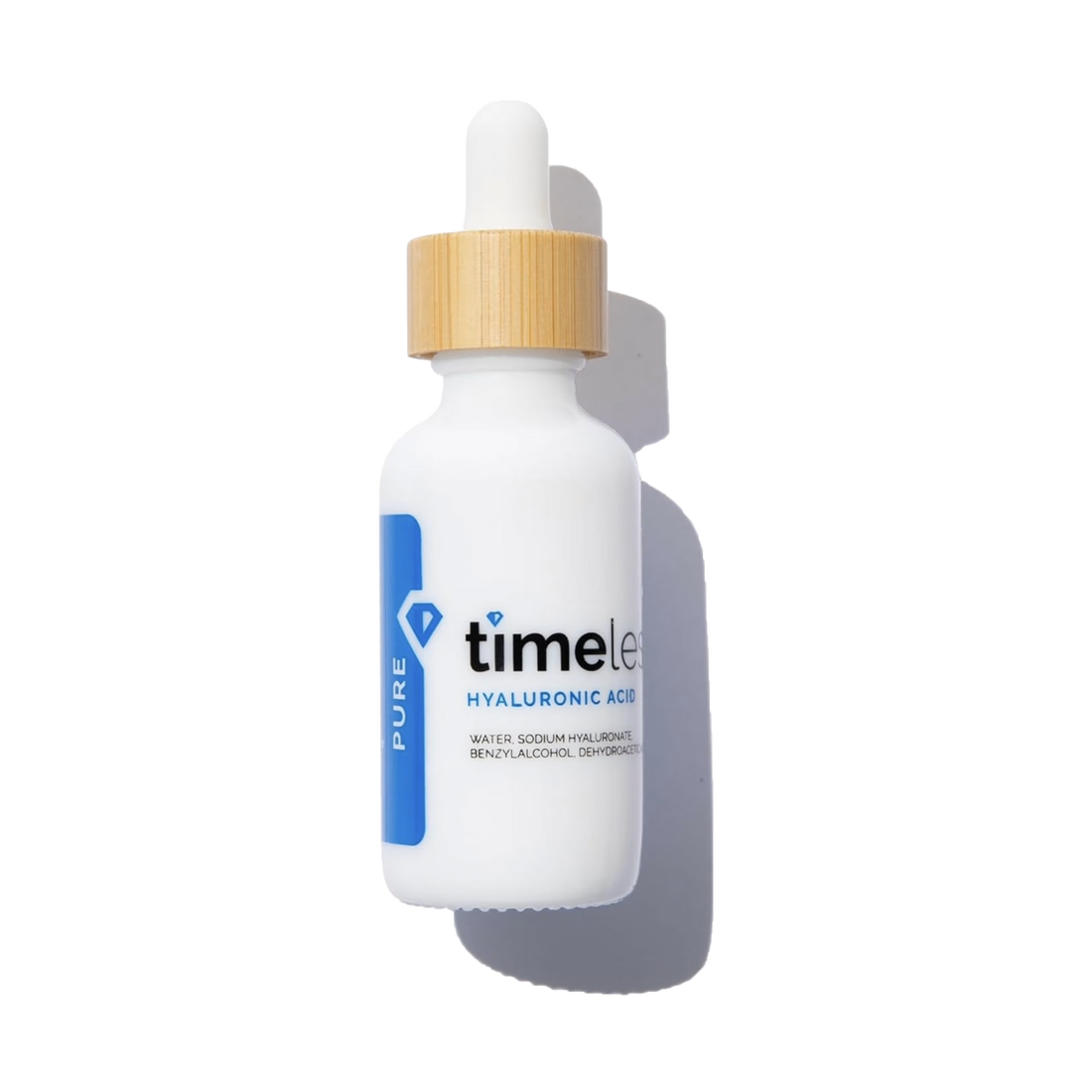 White dropper bottle with gold cap labeled 'timeless' on a white background
