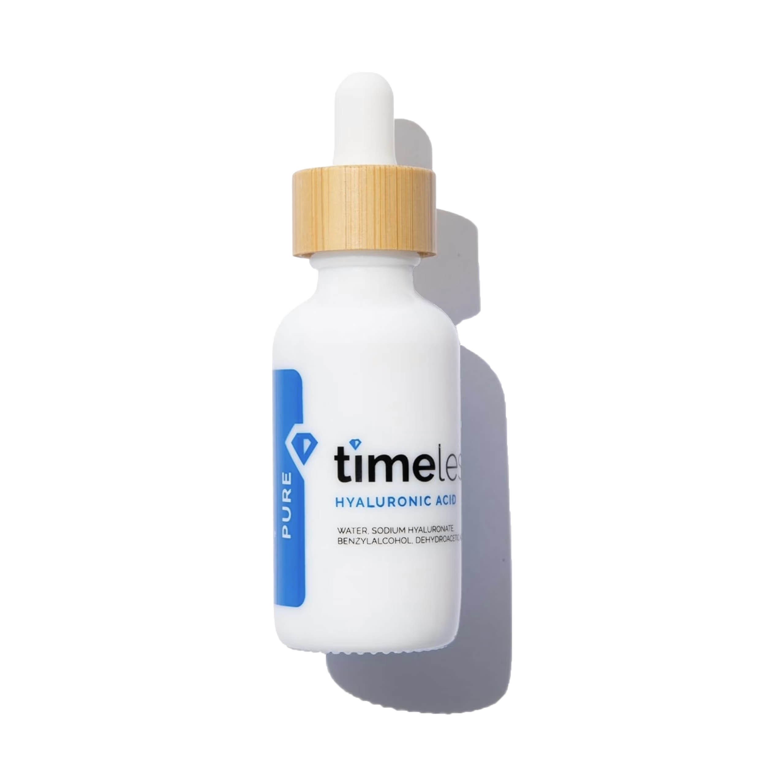 White dropper bottle with gold cap labeled 'timeless' on a white background
